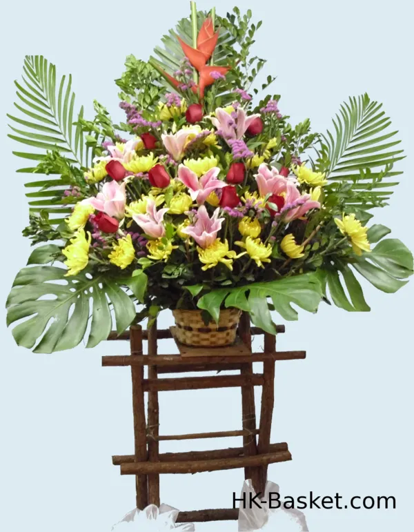 Flower arrangement  (4) - Our Ascent Arrangement, perched on a bamboo stand, features a cascade of pink lilies and red tulips, symbolizing rising fortunes and a bold future.